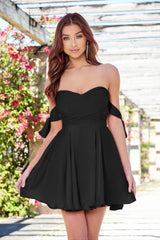 Woman wearing a black strapless dress with floral background