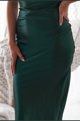 Green dress worn by a person with a blurred background