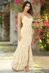 Woman in a floral dress standing outdoors with flowers in the background