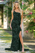 Woman wearing a black sequin dress with a slit outdoors.